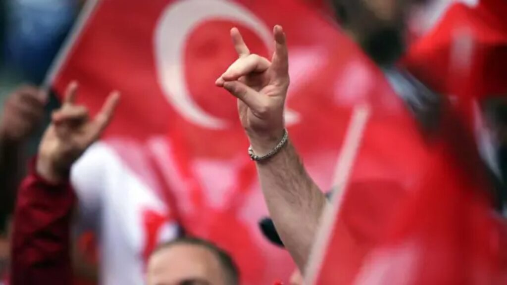 The Grey Wolves hand gesture, a far-right nationalist symbol in Turkey, represents the ultranationalist group known for promoting Armenophobia and ethnic hatred.