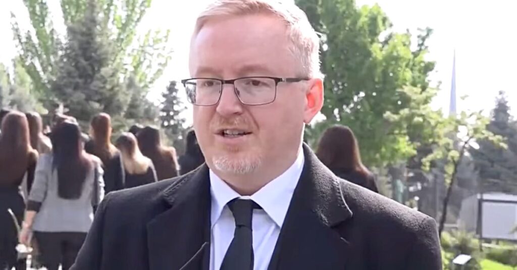 Ambassador Andrew Turner speaks at the Armenian Genocide Memorial in Yerevan during the 110th anniversary commemoration.