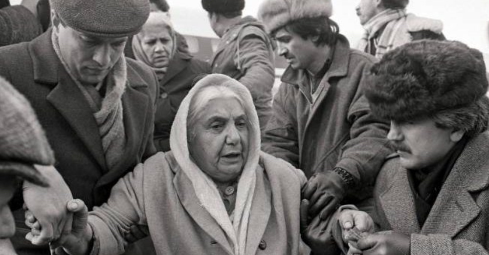 Elderly Armenian Woman Fleeing Baku | 1990 Pogrom Survivors | AGMC Archives An elderly Armenian woman is assisted by men during the mass evacuation of Armenians from Baku following the 1990 pogroms in Soviet Azerbaijan.
