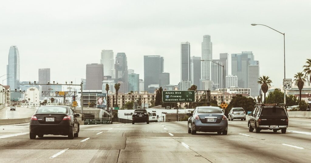 Downtown Los Angeles skyline viewed from the freeway, symbolic of the city’s 2025 civil rights investigation into alleged banking discrimination against Armenian-Americans.