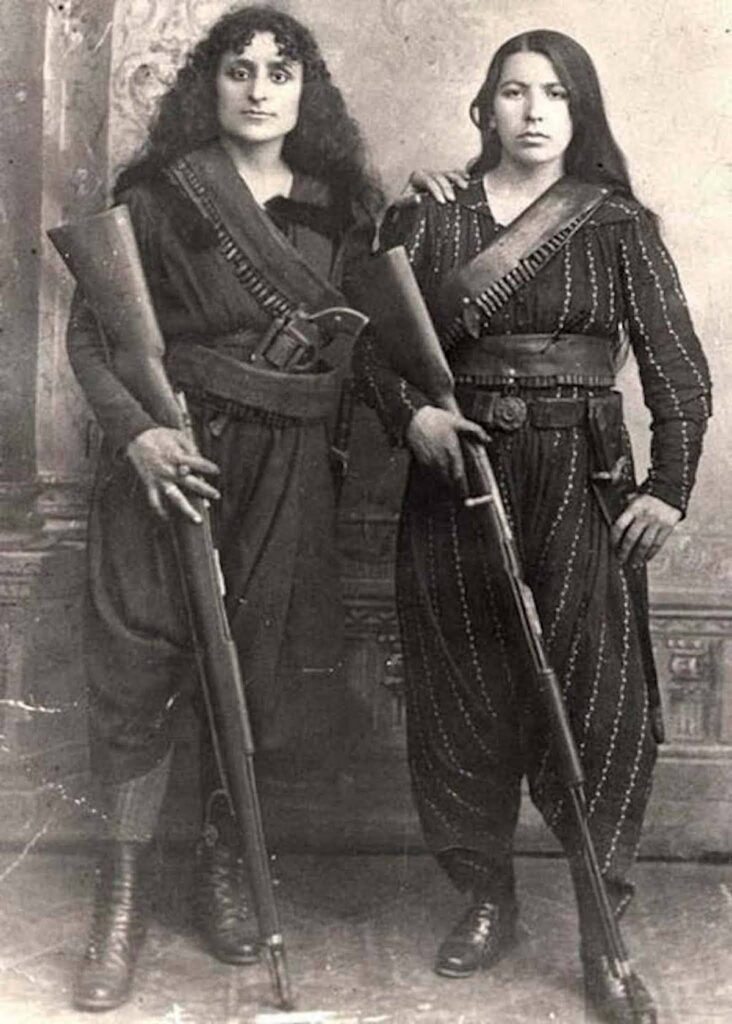 Historic photograph of two Armenian women fedayi fighters armed with rifles and bandoliers, symbolizing women’s resistance during the Armenian Genocide, circa early 20th century.