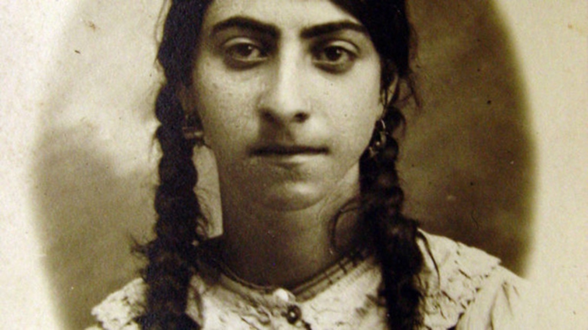 Portrait of Valentine Hakob, young Armenian Genocide survivor with braided hair, symbolizing the resilience of Armenian women.
