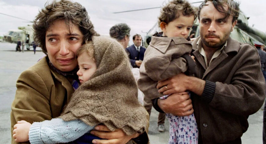 Armenian refugees from Nagorno-Karabakh carrying children after fleeing war and ethnic cleansing.